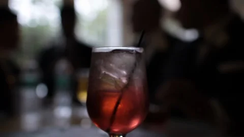 Alcoholic drink with men in background Stock Footage 96174271
