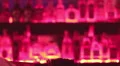Alcoholic drinks, bottles on bar shelf, bartender serving drinks HD Footage