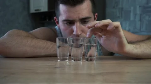 Alcoholic man drinking vodka from a shot Stock Footage 143563320