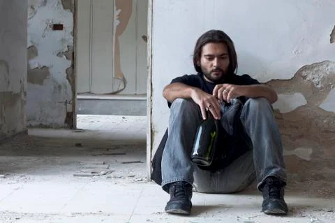 Alcoholic Sitting on the Floor Stock Photos