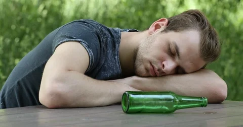 Alcoholic Young Man Lying and Sleeping o... | Stock Video