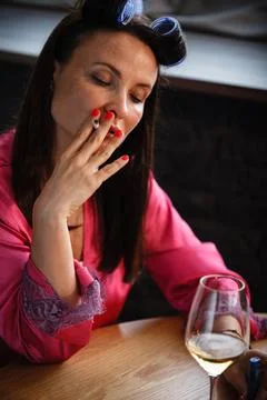 Alcoholism problem concept. Sad middle aged woman in stress sits in the kitchen Stock Photos