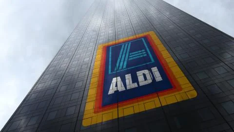 Aldi logo on a skyscraper facade reflecting clouds. Editorial 3D rendering 스톡 일러스트