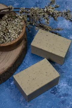 Aleppo soap and dray Laurus nobilis flower in a wooden plate . Stock Photos