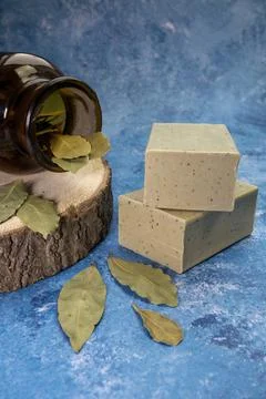 Aleppo soap and dray Laurus nobilis Leafs in a wooden plate and dark botanic Stock Photos