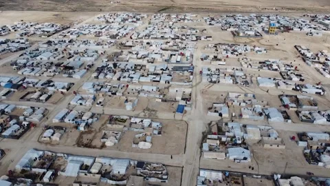 Aleppo, Syria - 01 March 2025: Aerial view of refugees camp with urban buildings Stock Footage 312736868