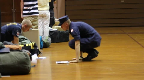 Alert Academy recruit does burpees while others study policy handbook Video stock 39213962