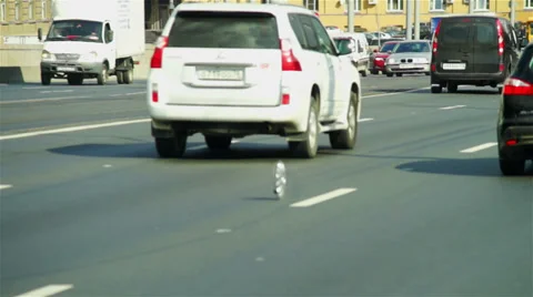 Alert condition: wheel disk rolling through roadway with many cars Video stock 36148132