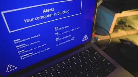 Alert screen on blocked computer appear in blue and various languages on desk Видео 328026594