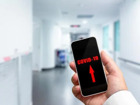 Alert simulation of covid-19 displayed on a doctor's mobile phone Stock Photos