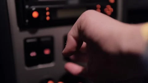 Alerting Safety: Activating Hazard Lights in a Car at Night Stock Footage 240472121