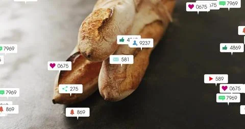 Alerts are popping as notification bubbles over 3 crusty baguettes on slate Stock Photos