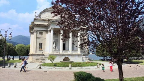 Alessandro volta temple in como with tourists walking Stock Footage 118649056