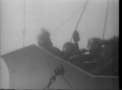 ALEUTIAN ISLANDS - 1943: Kiska task force — crewman working deck gear underway 库存影片 343135526