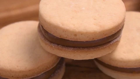 Alfajor and Dulce de Leche on Wood Board Pan Over Wood Video stock 129351517