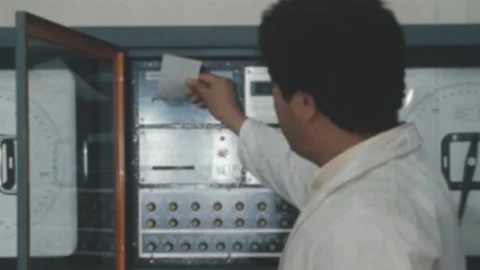 Algeria - 1980: Man operates on a machine in a production factory Видео 172138813