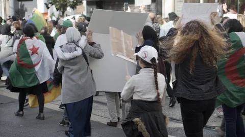 Algerians covered by flags protest in Marseille against president Bouteflika Stock Footage 104774916