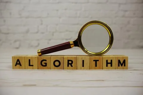 Algorithm alphabet letters and magnifying glass on wooden background Stockfoto's