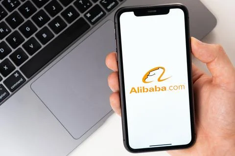 Alibaba mobile application on the smartphone screen. Make purchases while Stock Photos