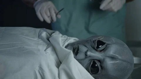 Alien Autopsy   close up of man operating on visitor Stock Footage 72957332