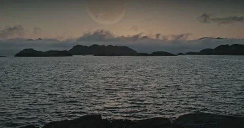 Alien beach and island with another planet and moon in the distance at sunset Stock Footage 255685686