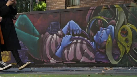 Alien graffiti and commuters inner city HD Stock Footage 154403530
