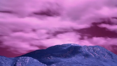 Alien landscape with mountain and long exposure clouds moving over it. Stock Footage 120052311