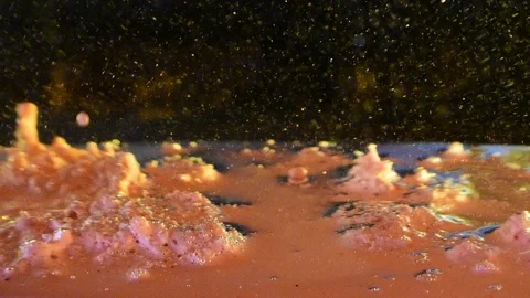 Alien planet liquid surface creating large bubble exploding to reveal Stockbeeldmateriaal 107758083