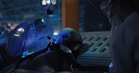 Alien is under observation in the laboratory. Scientist fixes sensors on an Video stock 102974625