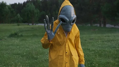 Alien waved his hand and welcomed.alien arrived on earth,actor in alien costume Stock Footage 142121582