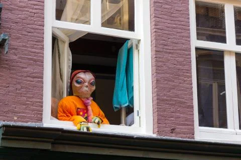 Alien in the window in the city 写真素材