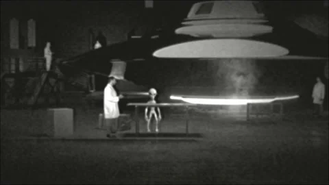 Alien Working with Humans Flying Saucer UFO in Hangar Stock Footage 162196439