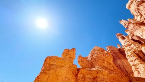 🛸 Alien World: Low Angle Red Rocks and Bright Sun in Bryce Stock Footage 337321347