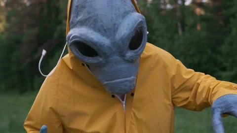 Alien in yellow suit is dancing . close up. concept of UFO Stock Footage 142122598