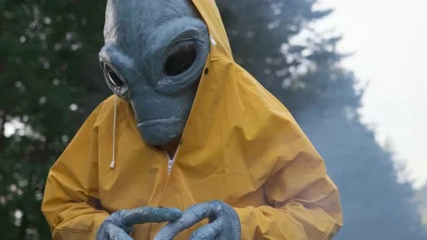 Alien in a yellow suit dancing in woods . close up. concept of a UFO Stock Footage 142122086