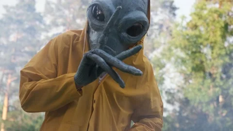 Alien in a yellow suit dancing in woods . close up. concept of a UFO Stock Footage 142122367