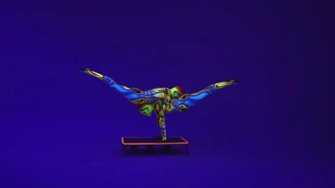 Aliens acrobats perform a pair of gymnastic elements on a blue cyclorama.uv Video stock 133425464