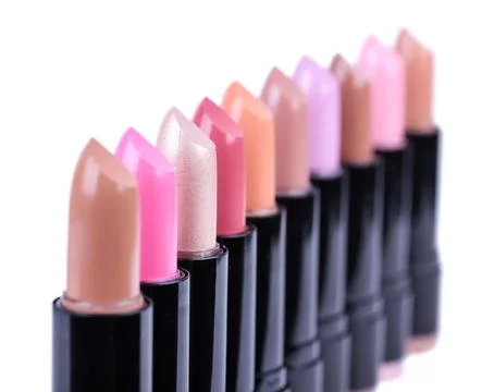 Align lipsticks different colours, closeup on white Stock Photos
