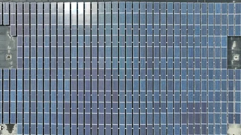 Aligned Array Of Solar Panels On Building Rooftop. Renewable Energy. aerial Stock Footage 306912767