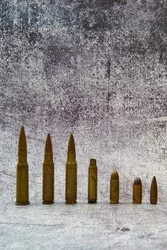 Aligned bullets of different calibres. Stock Photos