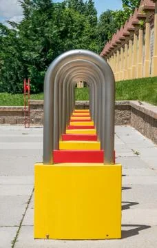 Aligned linear array of variously colored locks in a children's park. Fotos de archivo