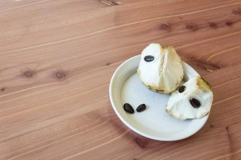 Aligned right small dish with chunks of ripe cherimoya fruit Annona cherimola Stock Photos