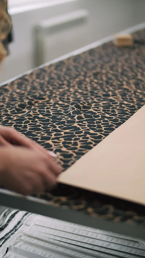 Aligning pattern on leopard print fabric Stock Footage 308724027