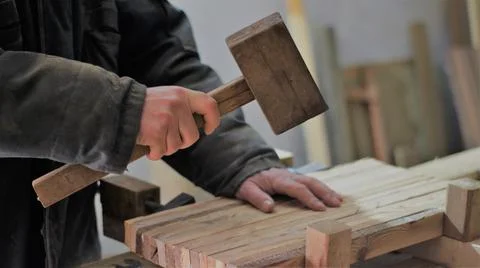 Alignment of glued boards with a mallet Stock Photos
