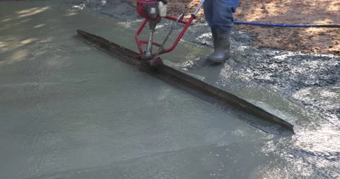 An alignment machine is used to align new concrete compacted layer of fresh Stock Footage 219545846