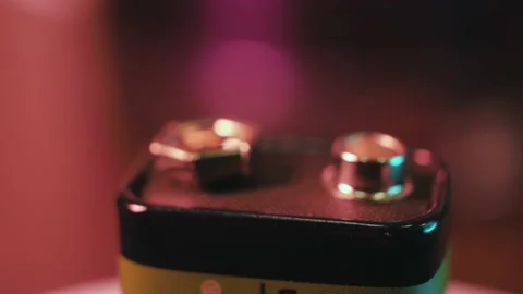 Alkaline battery rotates on a colored background Stock Footage 187038979