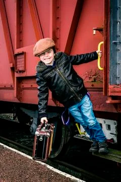 All aboard! boy hopped on train Stock Photos