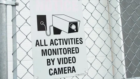 All activities monitored by video camera white rectangle sign with black print Stock Footage 247753748