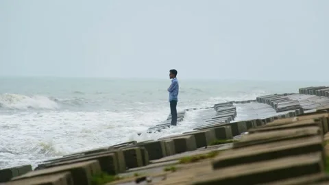 All alone as a young man flirts with the idea of drowning. Suicidal Stock Footage 255631038