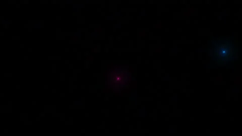 From all ends of the black screen, blue and red luminous particles fly out and Stock Footage 130407686